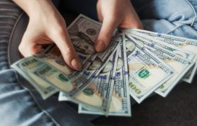Crisp US hundred dollar bills fanned out