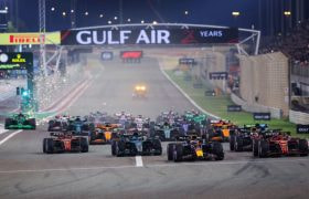 Cars race towards the opening turn in the 2024 F1 Grand Prix of Bahrain.