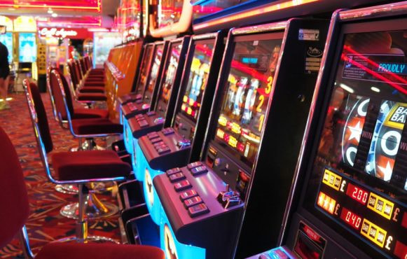 Long row of slot machines waiting to be played.