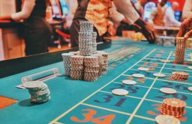 An image showing a casino table with large piles of chips