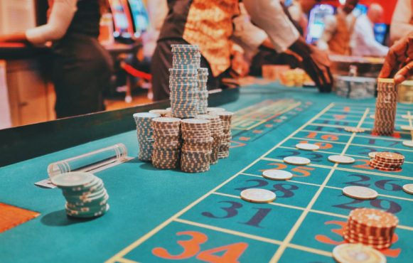 An image showing a casino table with large piles of chips