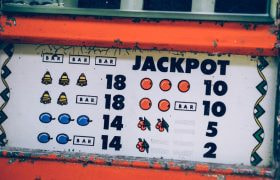 Vintage slot machine paytable showing classic symbols and jackpot amounts