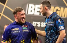 Luke Humphries and Luke Littler on a darts stage.