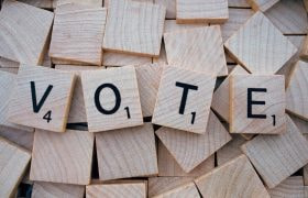 Four Letters Forming the Word 'Vote' in Scrabble