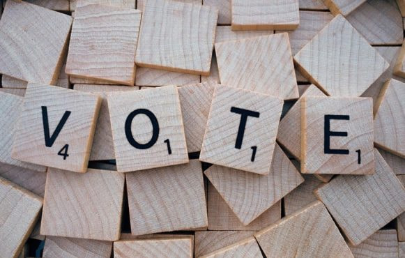 Four Letters Forming the Word 'Vote' in Scrabble