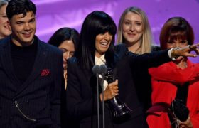 Claudia Winkleman holding the Reality Competition Award for 'The Traitors' at the National Television Awards 2024.