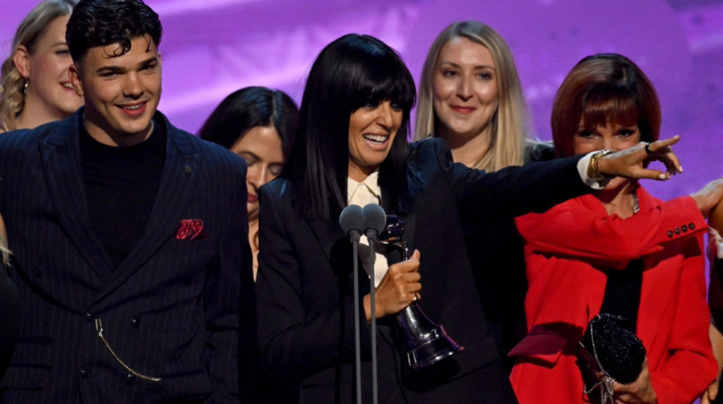 Claudia Winkleman holding the Reality Competition Award for 'The Traitors' at the National Television Awards 2024.