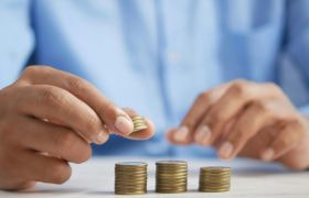 An image showing piles of coins demonstrating investment