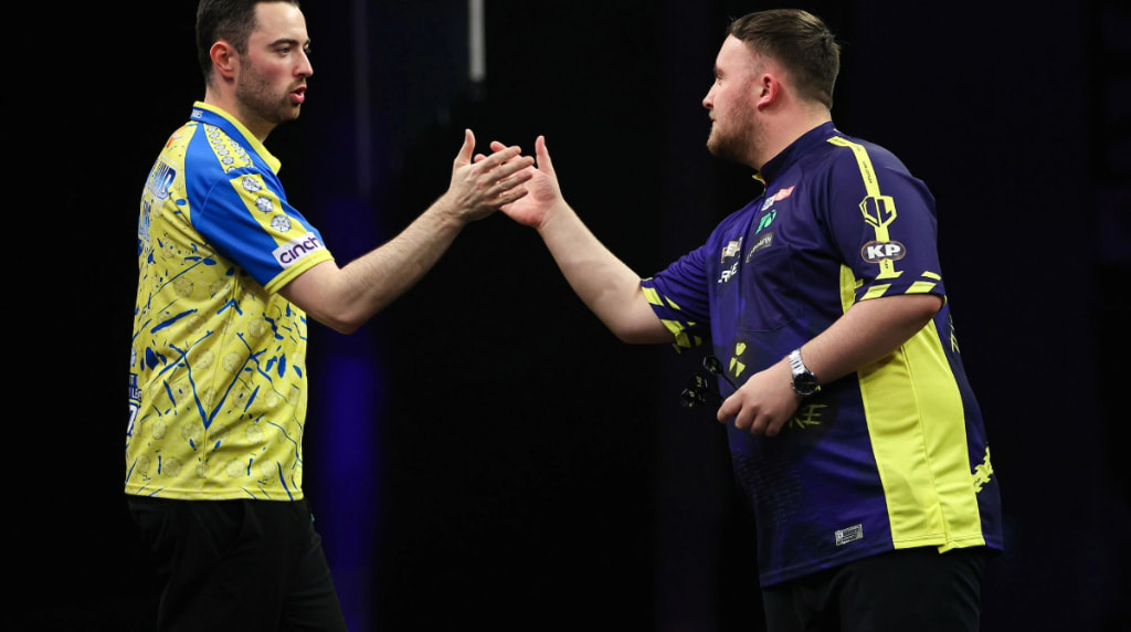 Luke Littler and Luke Humphries Shaking Hands on Stage.