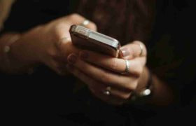 An image showing a person using a mobile phone for gambling