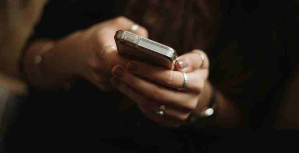An image showing a person using a mobile phone for gambling