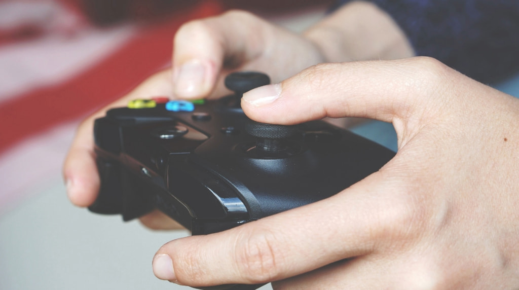 Someone Using a Controller to Play a Video Game
