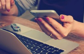 Someone Using Both a Phone and a Laptop