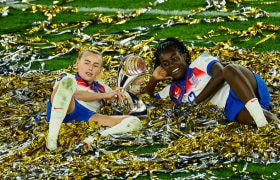 Chloe Kelly and Michelle Agyemang Celebrate with the UEFA Women's EURO Trophy.