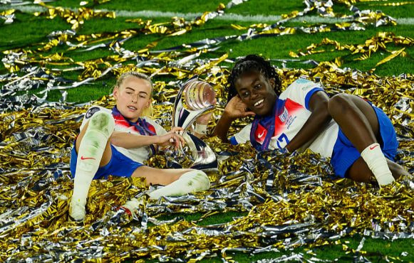 Chloe Kelly and Michelle Agyemang Celebrate with the UEFA Women's EURO Trophy.