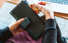 Someone Taking a Card Out to Make an Online Payment