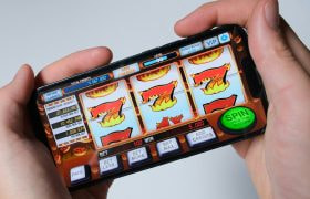Someone Playing a Slot on Their Phone