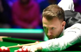 Snooker Star Judd Trump Taking a Shot.