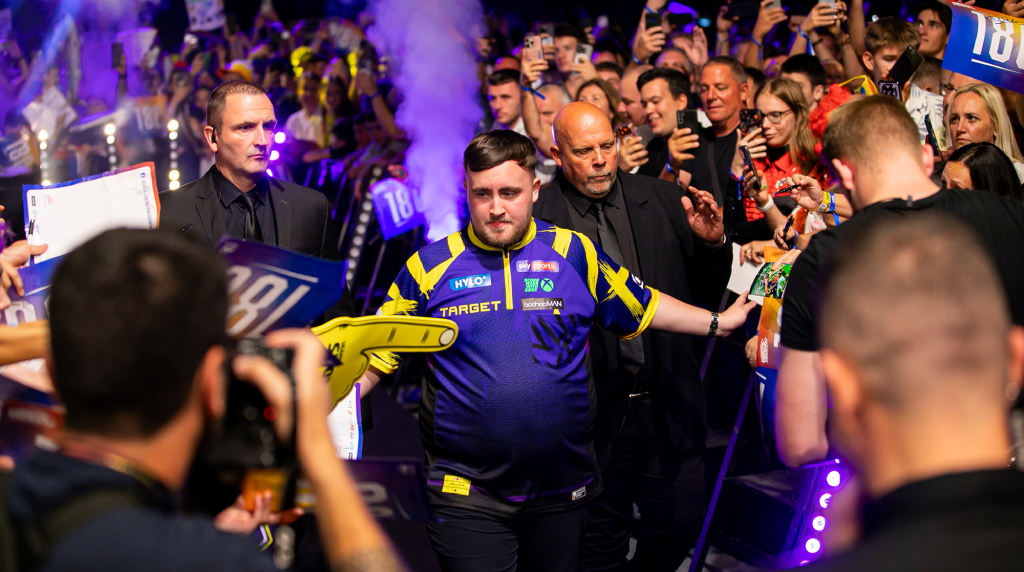 Luke Littler meeting fans as he walks toward the oche.