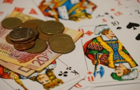 Playing cards, coins and bank notes