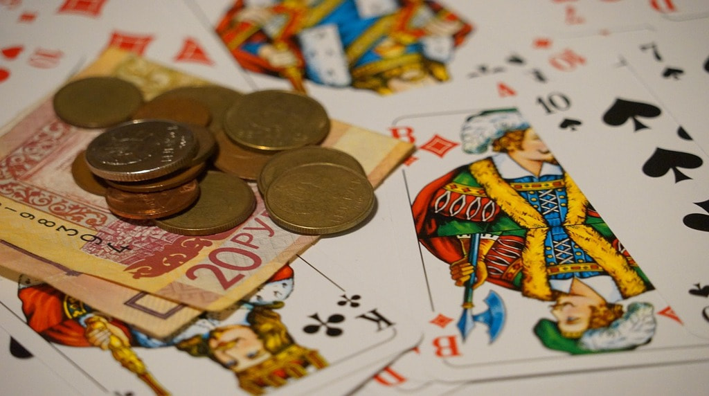 Playing cards, coins and bank notes