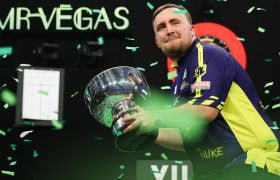 Luke Littler Shows off His 2024 Grand Slam of Darts trophy.