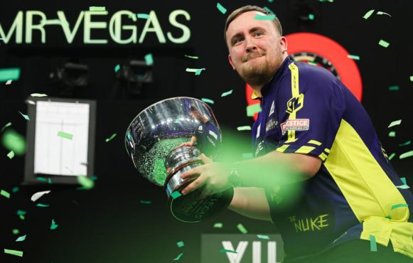 Luke Littler Shows off His 2024 Grand Slam of Darts trophy.