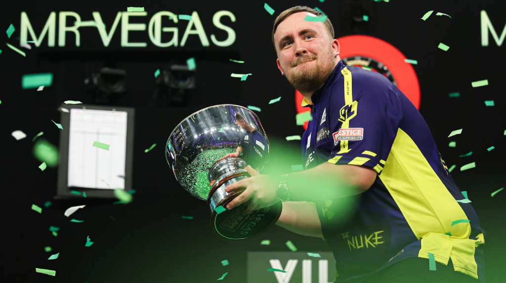 Luke Littler Shows off His 2024 Grand Slam of Darts trophy.