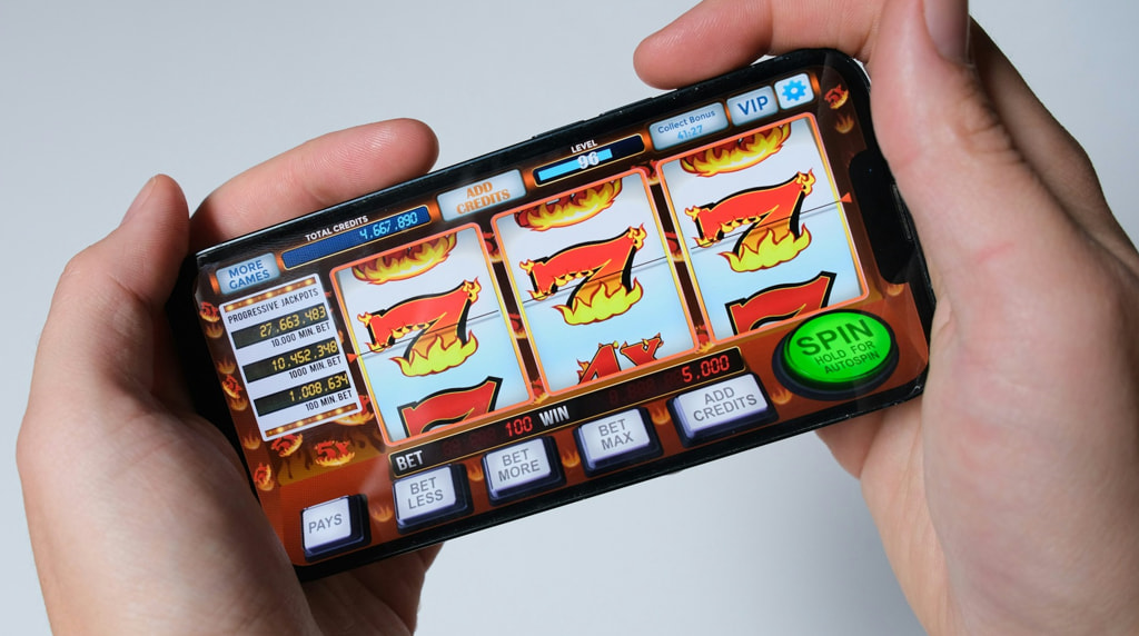 Someone Playing a Mobile Slot Game