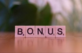 The Word "Bonus" Written with Scrabble Pieces