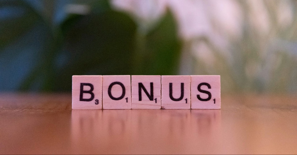 The Word "Bonus" Written with Scrabble Pieces