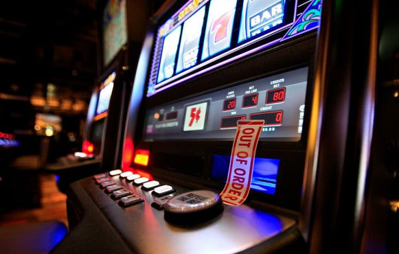 A Slot Machine with ‘Out of Order’ Tape Over Its Cash Slot.
