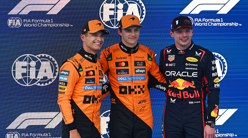 Oscar Piastri, Lando Norris and Max Verstappen pose for the cameras in Barcelona, Spain.