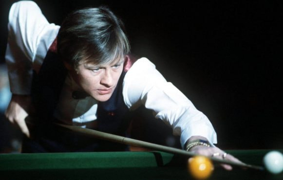 Alex Higgins lines up a shot at the 1984 Benson & Hedges Snooker Masters.