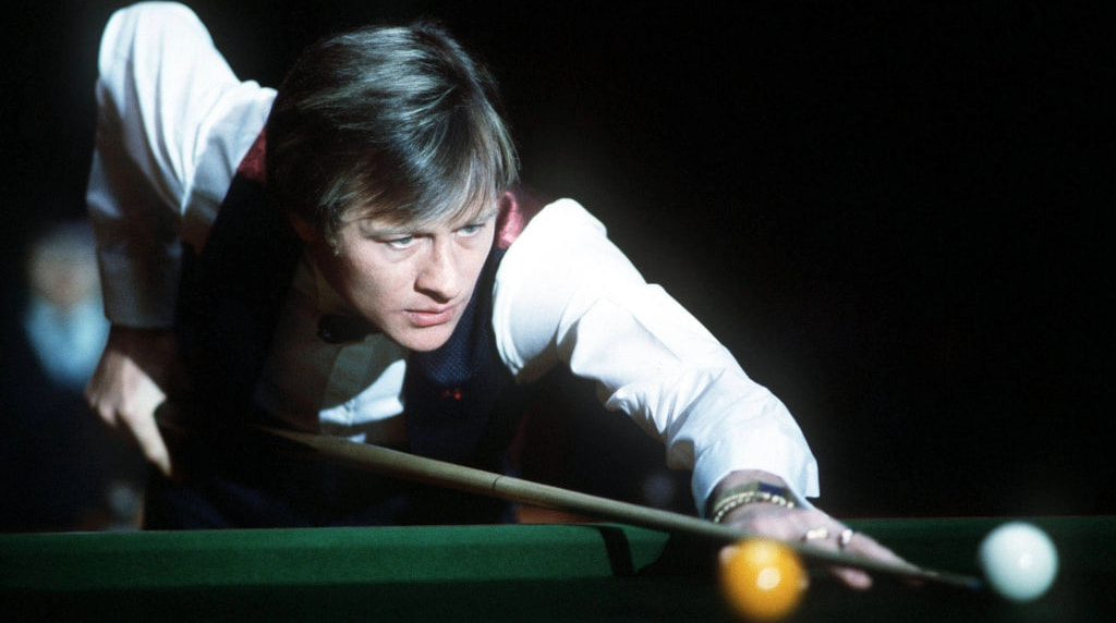 Alex Higgins lines up a shot at the 1984 Benson & Hedges Snooker Masters.