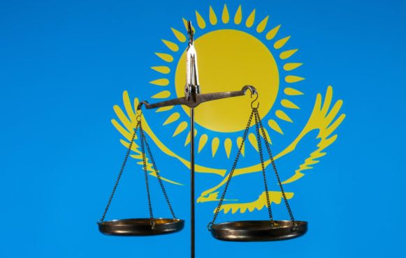 The Scales of Justice Against the Background of the Flag of Kazakhstan.