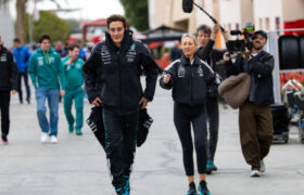 George Russell Walks into Bahrain International Circuit's Paddock, Followed by a Netflix Crew.