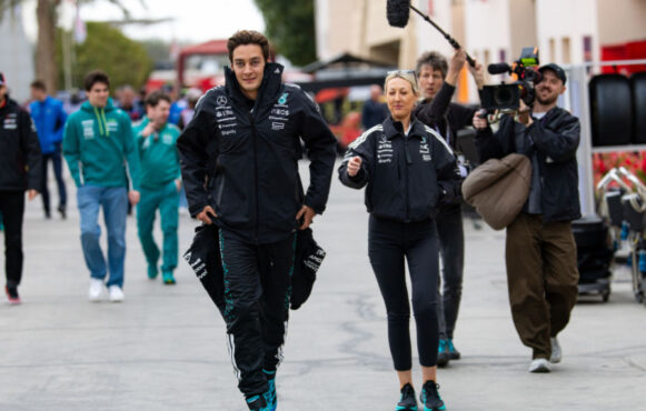 George Russell Walks into Bahrain International Circuit's Paddock, Followed by a Netflix Crew.