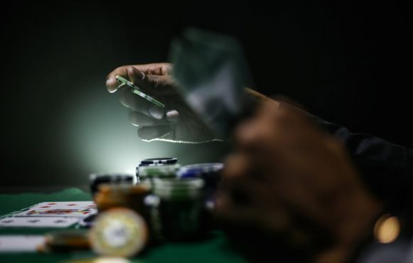 Casino Player Holding Gambling Chips