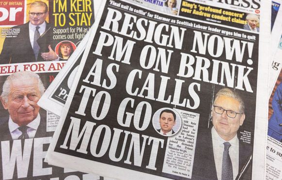 A Daily Express newspaper cover shows Sir Keir Starmer with a headline stating there is calls for his resignation.