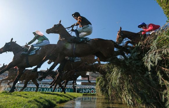Patrick Mullins Riding Nick Rockett Clears the Water Jump on Their Way to Winning the 2025 Grand National.