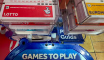 UK National Lottery Slips Are Displayed at a National Lottery Ticket Desk.
