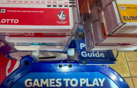 UK National Lottery Slips Are Displayed at a National Lottery Ticket Desk.