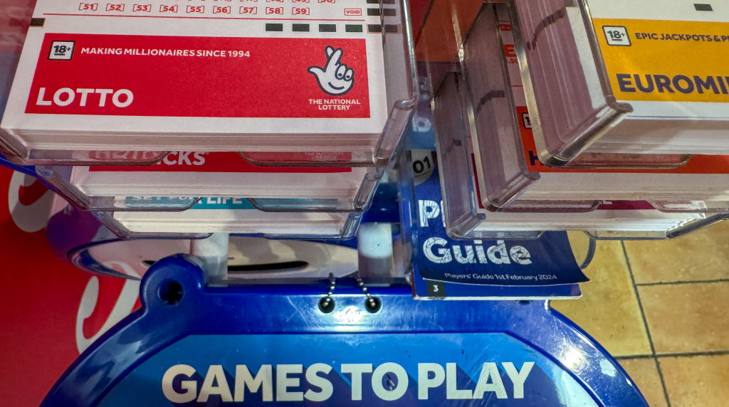 UK National Lottery Slips Are Displayed at a National Lottery Ticket Desk.