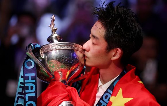 Wu Yize Kisses the Halo World Snooker Championship trophy.