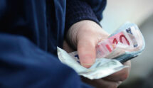 A Bookmaker Holds a Handful of Euro Notes at Curragh Racecourse.