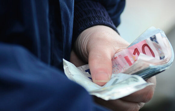 A Bookmaker Holds a Handful of Euro Notes at Curragh Racecourse.