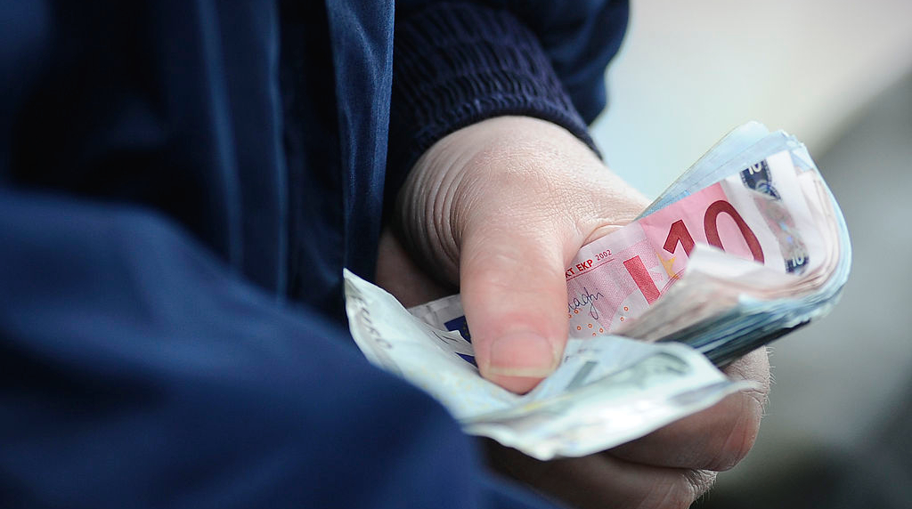 A Bookmaker Holds a Handful of Euro Notes at Curragh Racecourse.