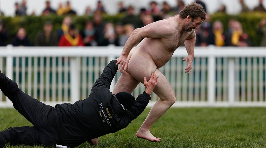 A Groundsman Attempts to Tackle a Streaker During 2016s Gold Cup Day at the Cheltenham Festival.