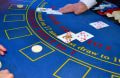 Kortuddeling på blåt blackjack bord.